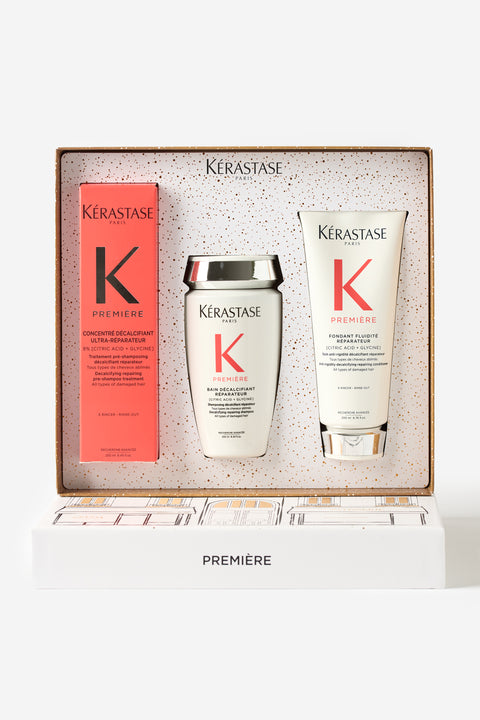 Coffret cadeau du temps des fêtes de Kérastase de la gamme Première qui inclut un bain décalcifiant réparateur, un fondant fluidité réparateur et un concentré décalcifiant ultra-réparateur.