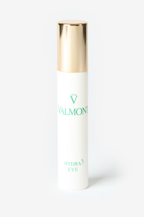 Une bouteille blanche Valmont avec un capuchon doré. 