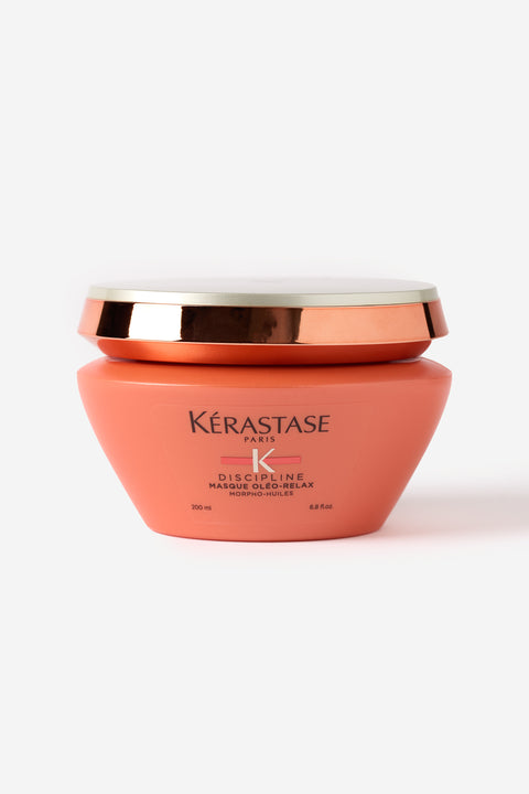 Le masque de la gamme discipline de Kérastase dans un pot orange saumon.