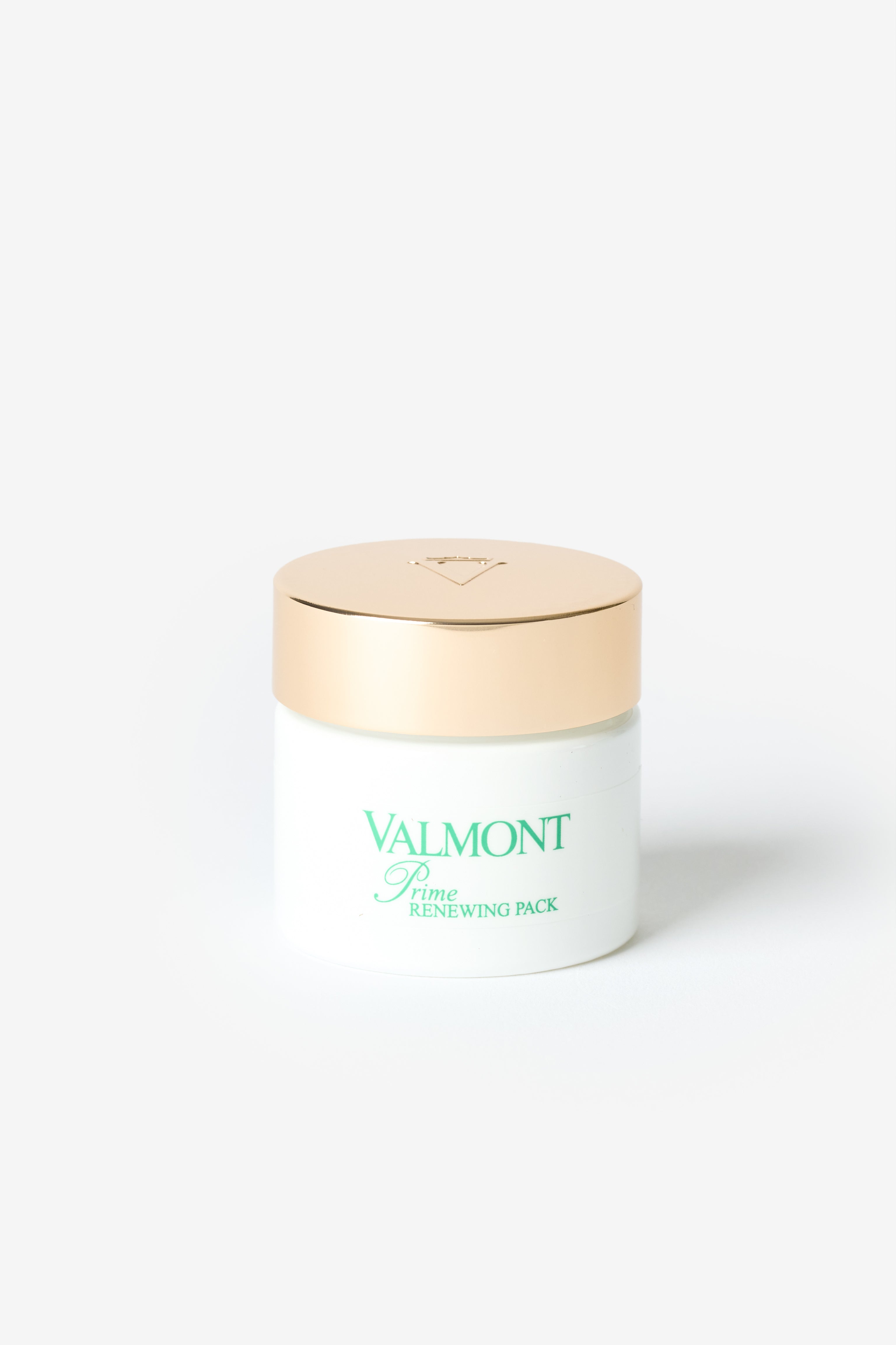 Un pot blanc Valmont avec couvercle doré.