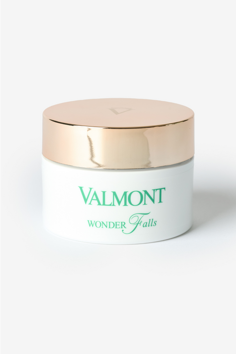 Un pot blanc Valmont avec un couvercle doré.