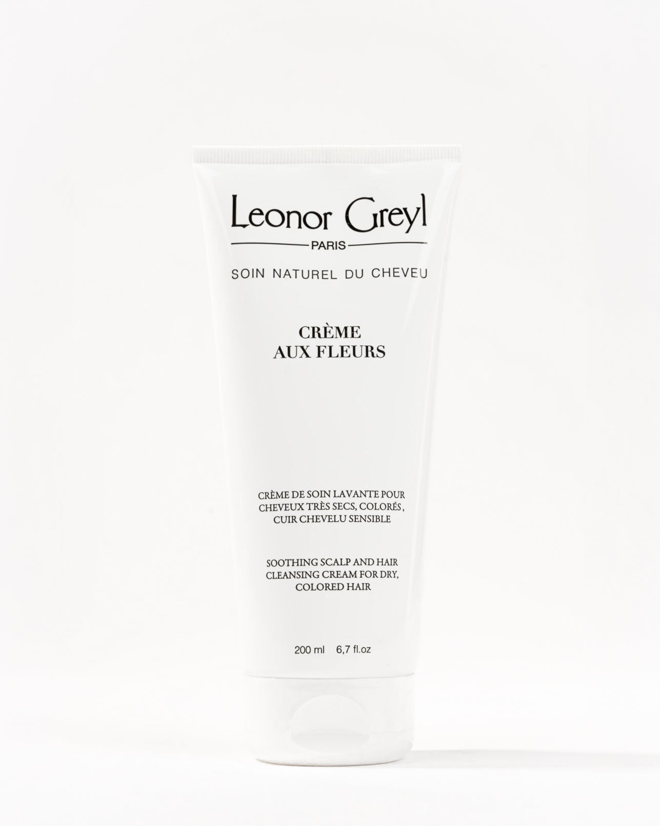 Bouteille blanche de la crème de soin lavante Crème aux Fleurs de Leonor Greyl
